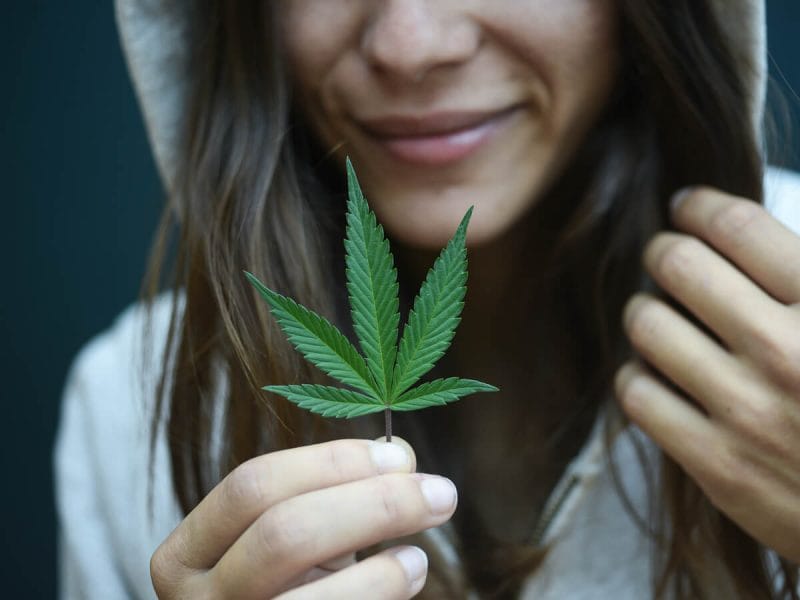 hooded girl with marijuana leaf