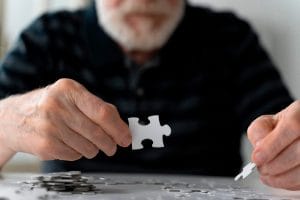gentleman with Alzheimers doing a puzzle